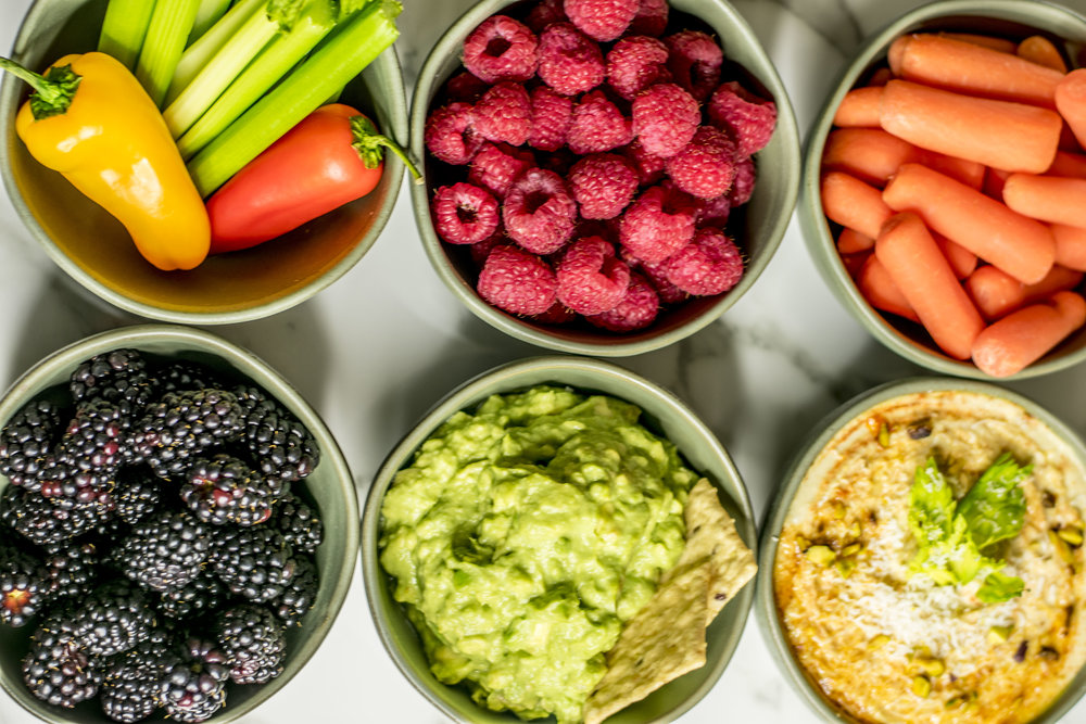 Six small bowls with fruits