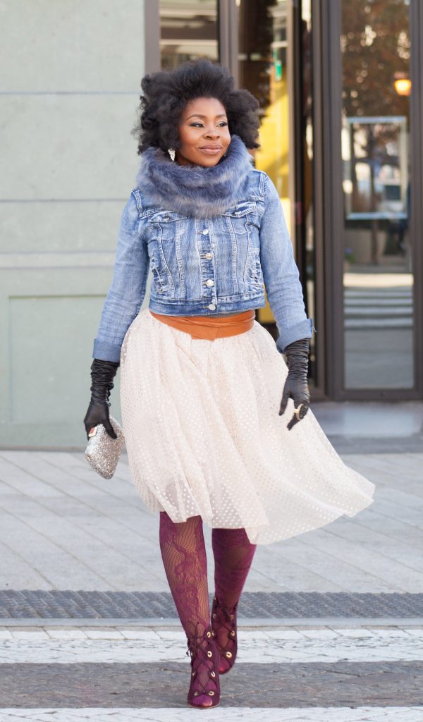 woman wearing jean jacket crossing the street
