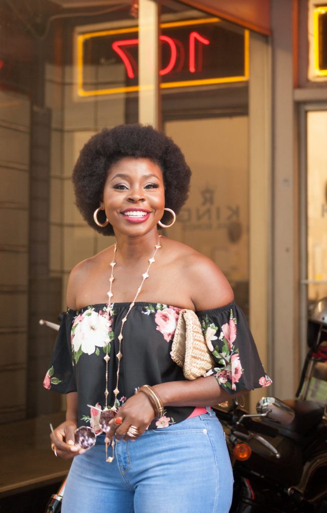 Woman wearing a off shoulder blouse smiling