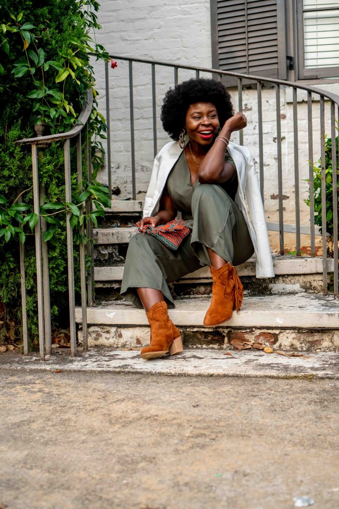 woman sitting on a stairs outside dressed nicely